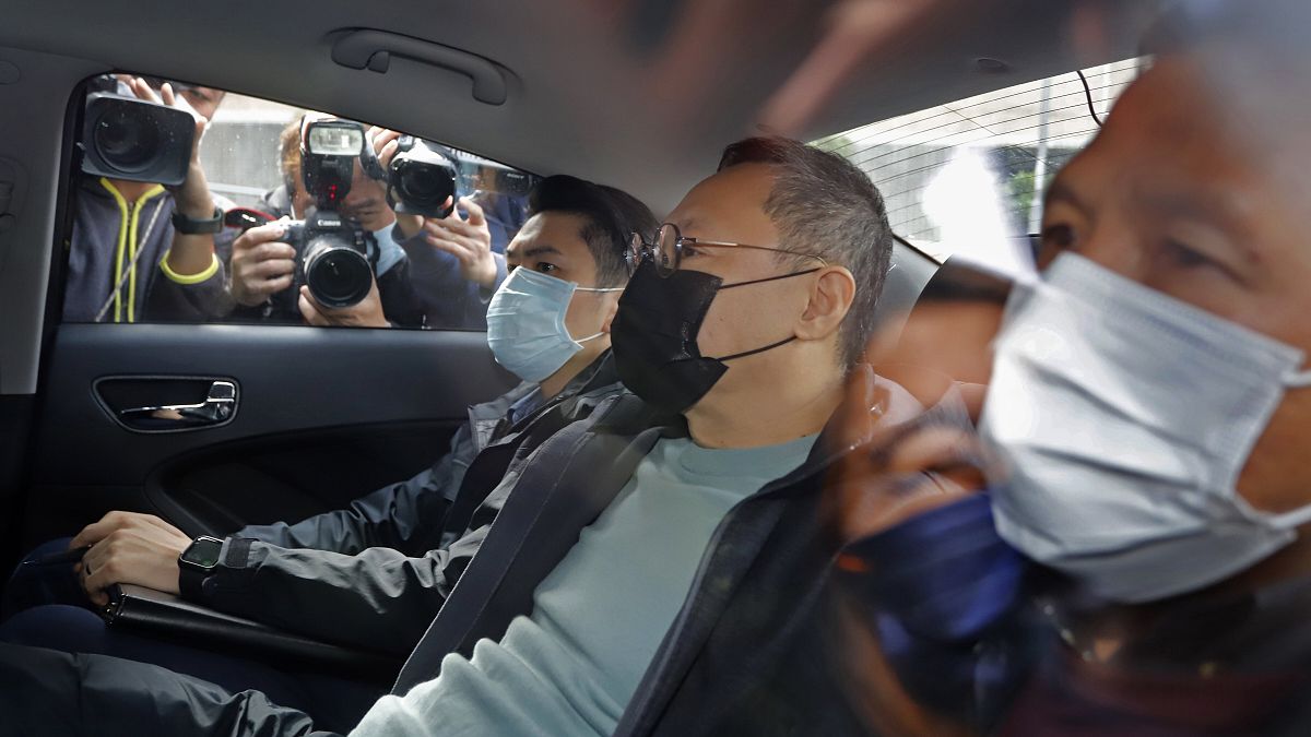 Former law professor Benny Tai, centre, a key figure in Hong Kong's 2014 Occupy Central protests after being arrested by police in Hong Kong, Wednesday, Jan. 6, 2021.