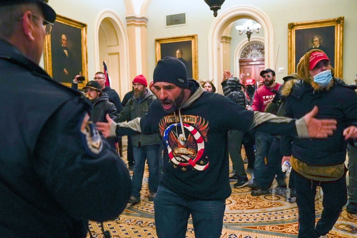 Trump supporters in front of U.S. Capitol Police in the hallway outside of the Senate chamber at the Capitol in Washington, USA. January 6, 2021