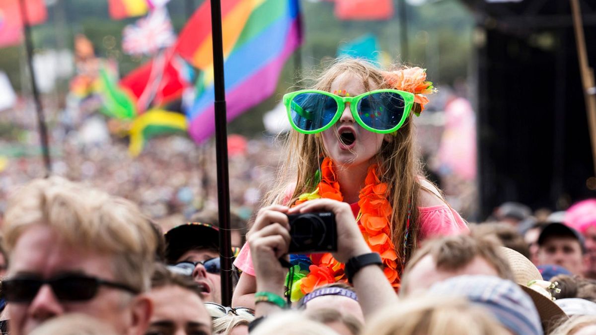 A young fan enjoys the music at the Glastonbury Festival at Worthy Farm, in Somerset, England, Sunday, June 25, 2017