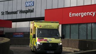 An ambulance drives of a hospital in London, Wednesday, Dec. 30, 2020.
