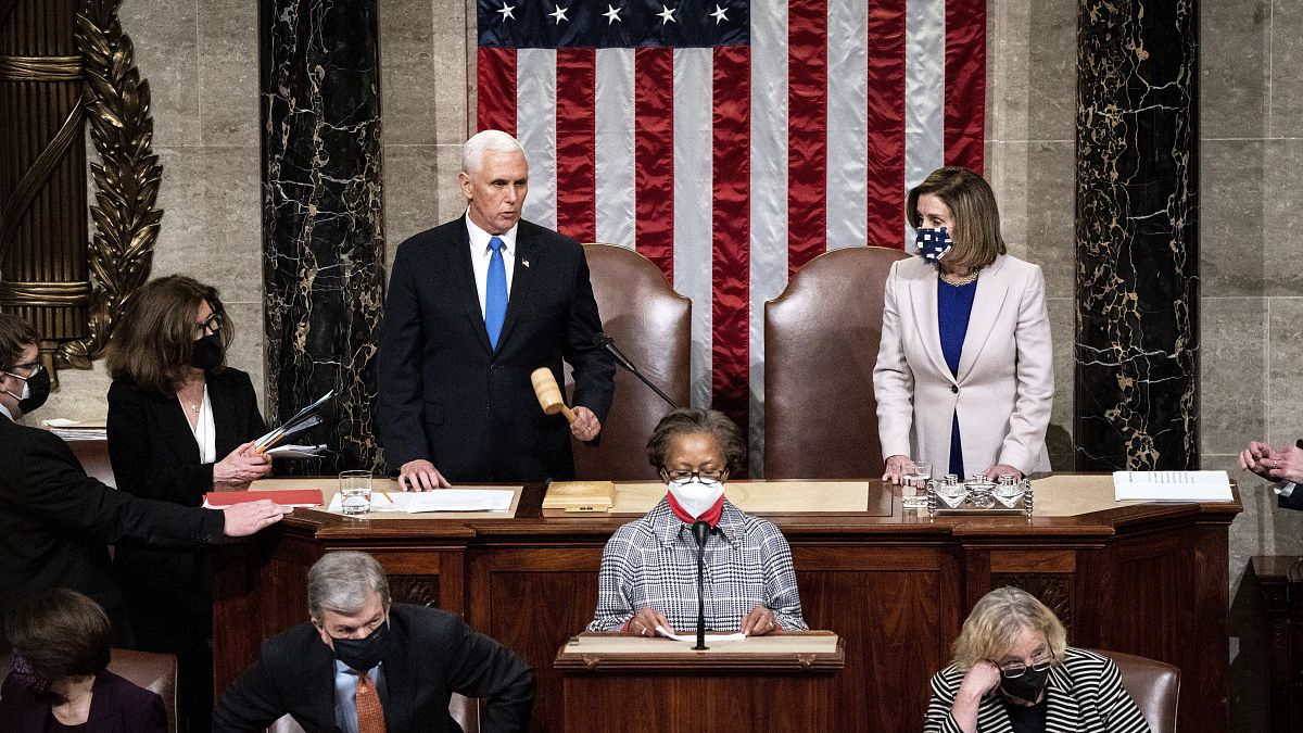 Speaker of the House Nancy Pelosi, D-Calif., and Vice President Mike Pence officiate as a joint session of the House and Senate on January 6, 2021.