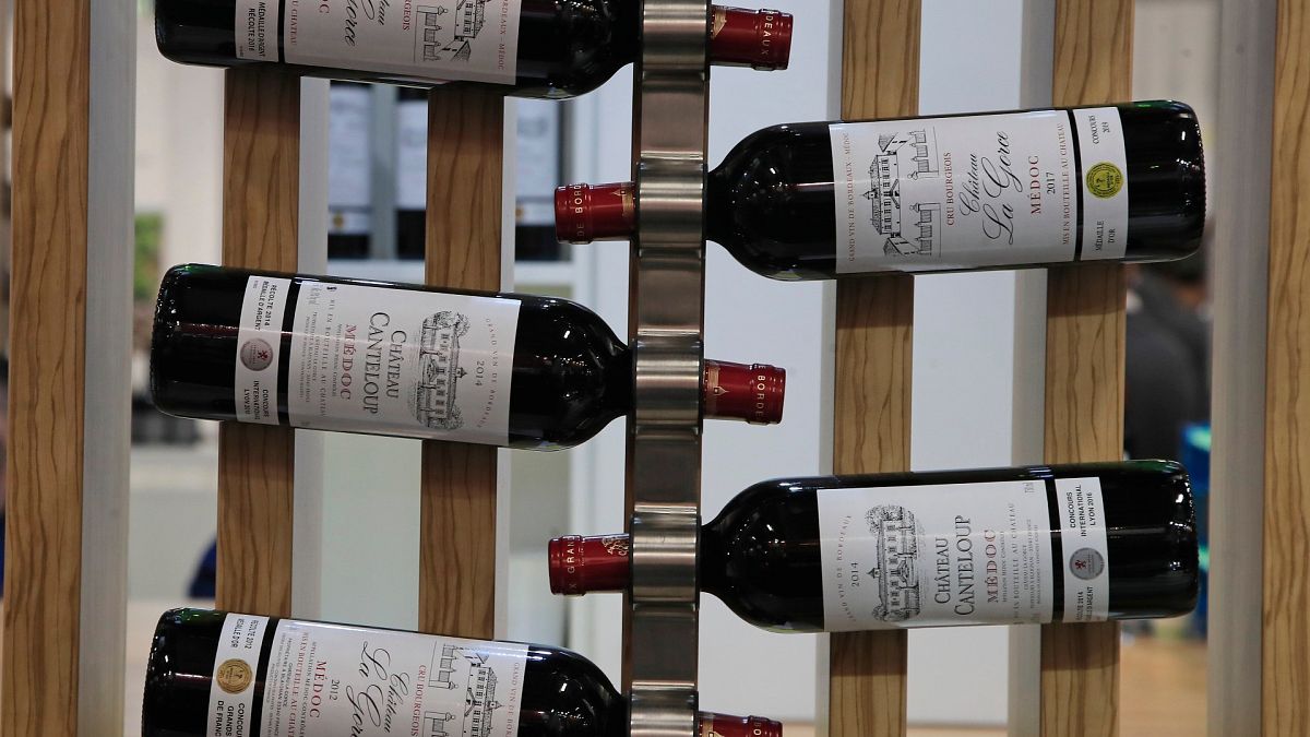 Red wine bottles of the region of Medoc, western France, are displayed at the wine fair in Paris in February 2020.