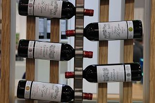 Red wine bottles of the region of Medoc, western France, are displayed at the wine fair in Paris in February 2020.