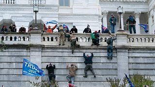 Supporters of President Donald Trump climb the west wall of the the U.S. Capitol on Wednesday, Jan. 6, 2021, in Washington. 