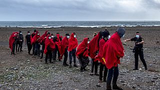 Migrants from Morocco walk on a beach on the Canary island of Gran Canaria, Spain on Friday