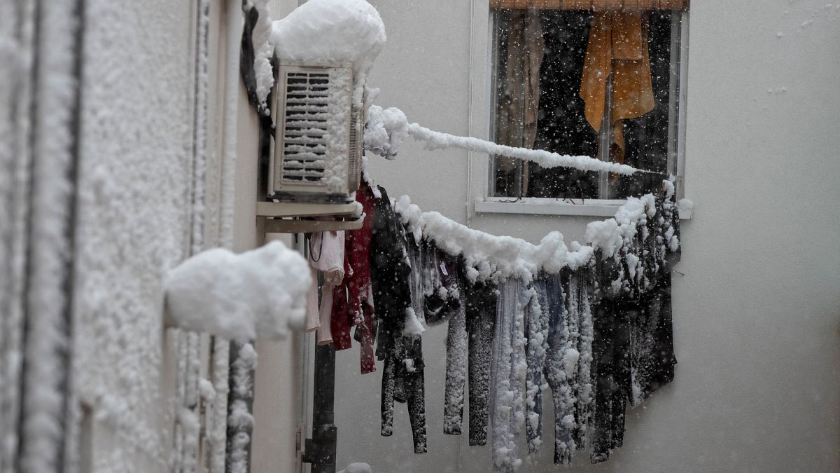 Frozen laundry hangs on a line outside an apartment window after a heavy snowfall in Madrid, Spain, Saturday, Jan. 9, 2021.