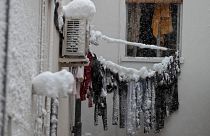 Frozen laundry hangs on a line outside an apartment window after a heavy snowfall in Madrid, Spain, Saturday, Jan. 9, 2021.