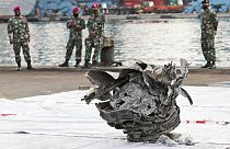 Investigators of Indonesian National Transportation Safety Committee inspect parts of Sriwijaya Air SJ-182 recovered from the Java Sea where it crashed on Saturday 9 Jan. 2021