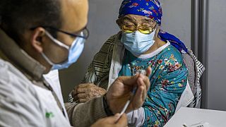 A woman receives a Pfizer-BioNTech coronavirus vaccine in Jerusalem  - Jan. 10, 2021.