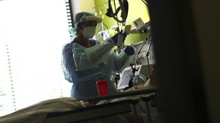 File: In this Wednesday, April 29, 2020 photo a nurse assists a COVID-19 patient at one of the intensive care units of the hospital in Muehldorf am Inn, Germany. 