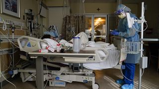 Registered nurse Merri Lynn Anderson tends to her patient in a COVID-19 unit at St. Joseph Hospital in Orange, Calif. Thursday, Jan. 7, 2021. 