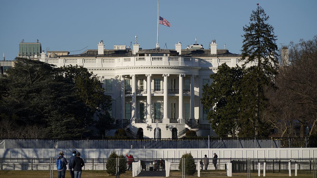 An US flag flies at half-staff above the White House in Washington, Sunday, Jan. 10, 2021.