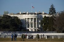 An US flag flies at half-staff above the White House in Washington, Sunday, Jan. 10, 2021.