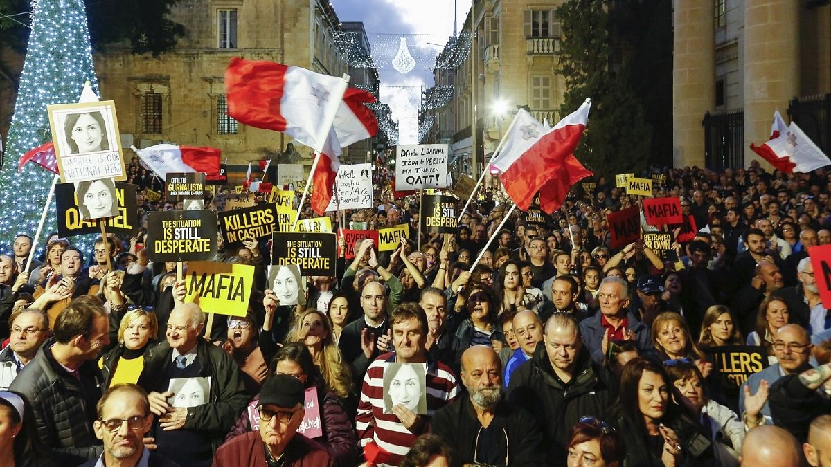 People stage a protest in Valletta, Malta, Sunday, Dec. 1, 2019.