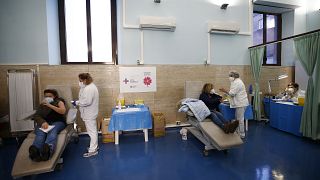 Medical staff is vaccinated against COVID-19 at a Rome hospital, Monday, Jan. 4, 2021.