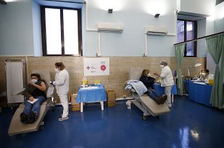 Medical staff is vaccinated against COVID-19 at a Rome hospital, Monday, Jan. 4, 2021.