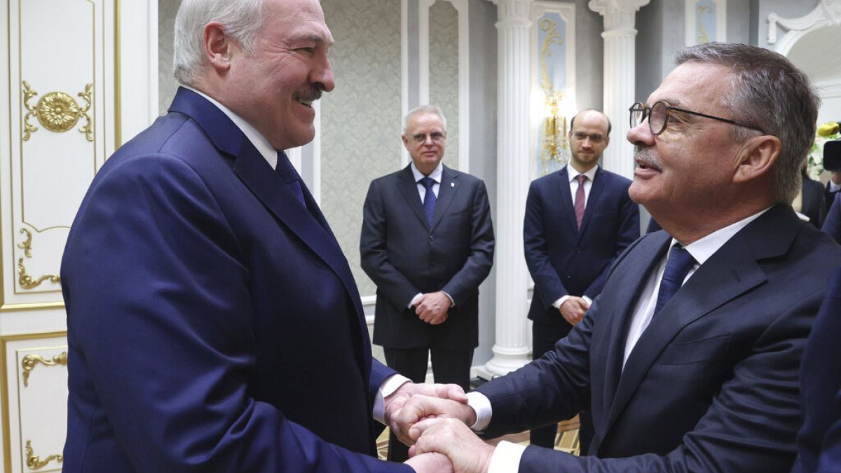 Belarusian President Alexander Lukashenko, left, greets International Ice Hockey Federation President Rene Fasel during their meeting in Minsk, Belarus, Monday, Jan. 11, 2021.