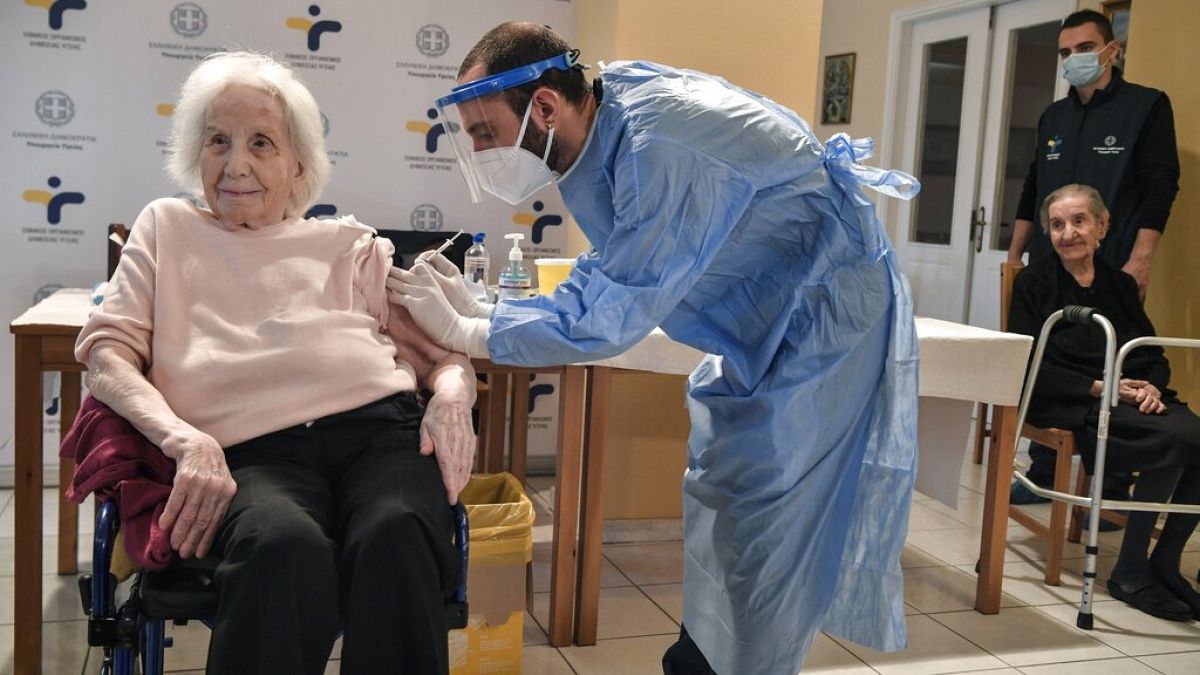An elderly woman gets a vaccination at a nursing house in Athens