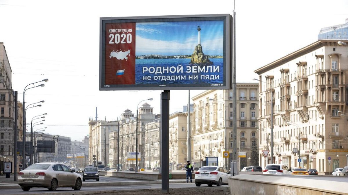 A billboard with a picture of Sevastopol that reads: "Not an inch of our Dear Land to be Surrendered" is displayed in Moscow, Russia, Wednesday, March 25, 2020.