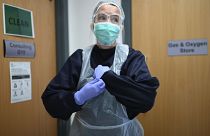 In this Tuesday, June 9, 2020 photo, Doctor Nathalie Dukes dons PPE, personal protective equipment as she tests the measures taken by the practice to receive COVID patients.