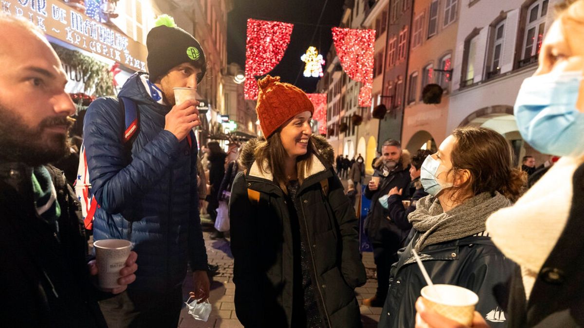 In this Dec. 17, 2020 file photo, people enjoy a glass of mulled wine in the street before the curfew in Strasbourg, eastern France.