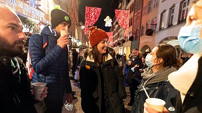 In this Dec. 17, 2020 file photo, people enjoy a glass of mulled wine in the street before the curfew in Strasbourg, eastern France.