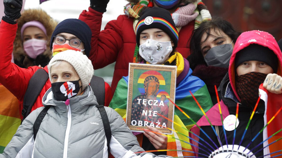 Human rights activists show an altered image with colors symbolizing LGBT rights as they gathered outside the provincial court in Plock, Poland, Jan. 13, 2021  