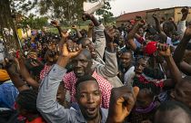 Supporters of leading opposition challenger Bobi Wine cheer as election officials count the ballots after polls closed in Kampala, Uganda, Thursday, Jan. 14, 2021.