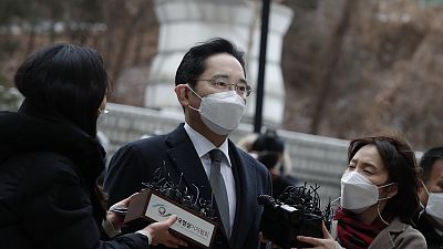Samsung Electronics Vice Chairman Lee Jae-yong is questioned by reporters upon his arrival at the Seoul High Court in Seoul, South Korea, Monday, Jan. 18, 2021.