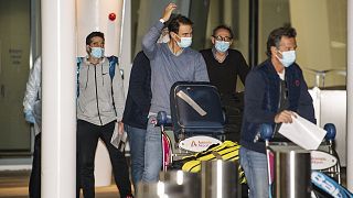 Spain's Rafael Nadal, center, arrives at Adelaide Airport ahead of the Australian Open tennis championship, Adelaide, Australia, Thursday, Jan. 14, 2021.