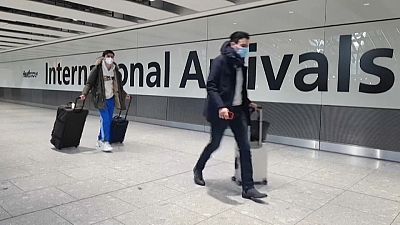 Passengers arrive at Heathrow airport the day before the UK government closes all travel corridors