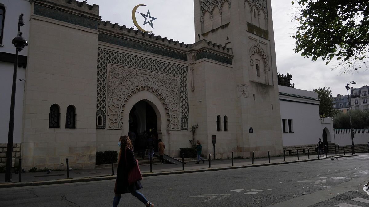 A woman walks outside the Paris mosque, Thursday, Oct. 29, 2020.