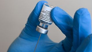 A health worker fills a syringe with the Pfizer-BioNTech COVID-19 vaccine against the novel coronavirus