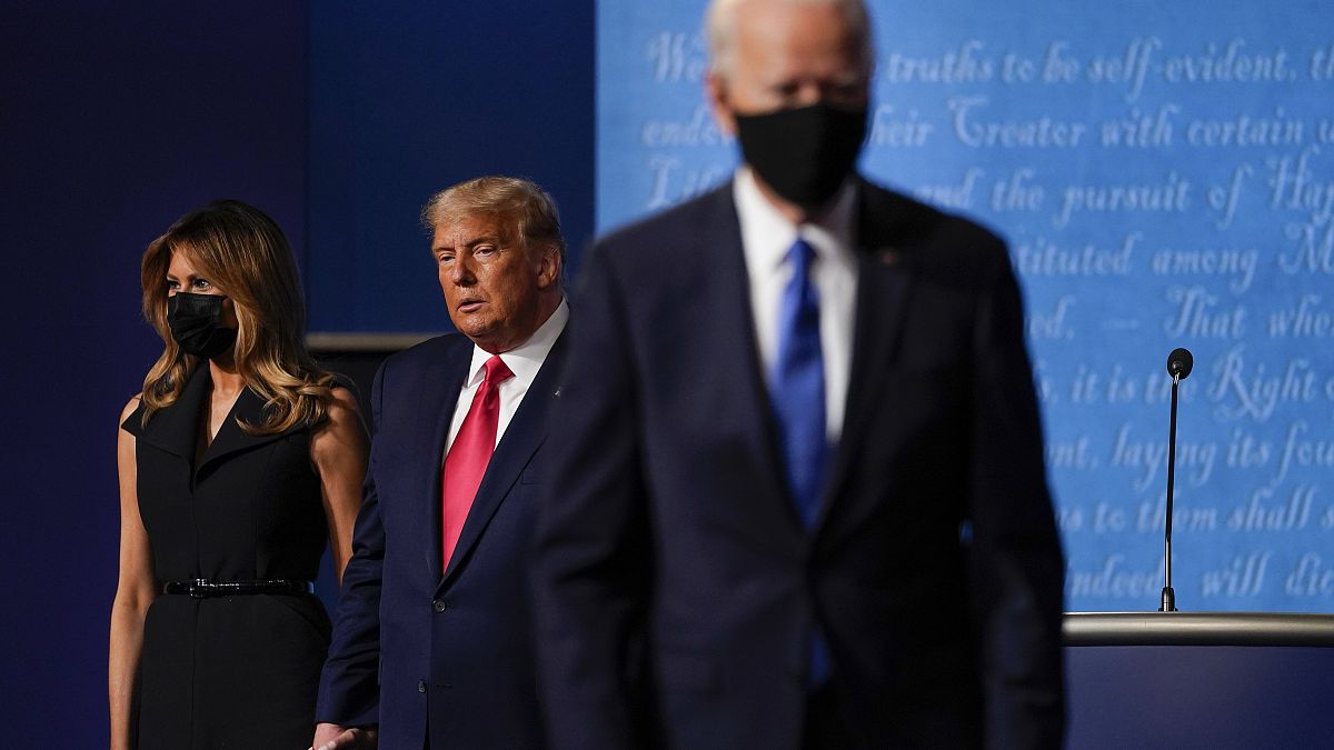 In this Oct. 22, 2020, file photo Melania Trump, left, and US President Donald Trump, centre, on stage as now President-elect Joe Biden leaves after a debate.