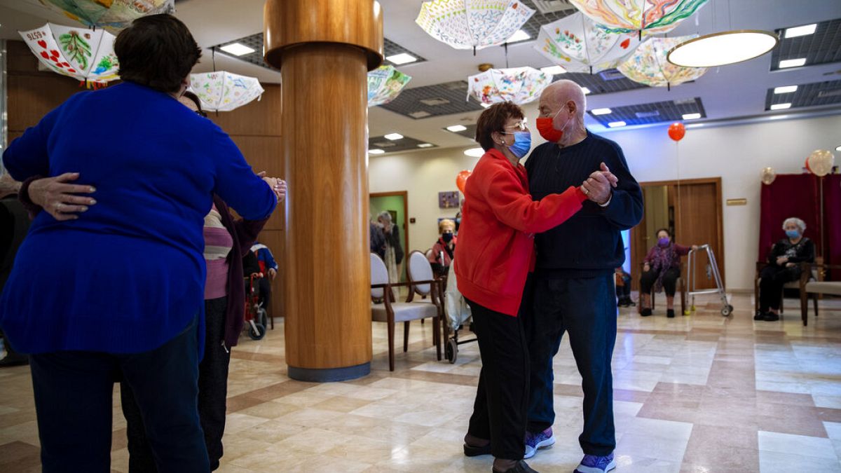 Tzvika Sermik, 92, right, and Virginia Wendel, 86, dance after they received their second Pfizer-BioNTech COVID-19 vaccine