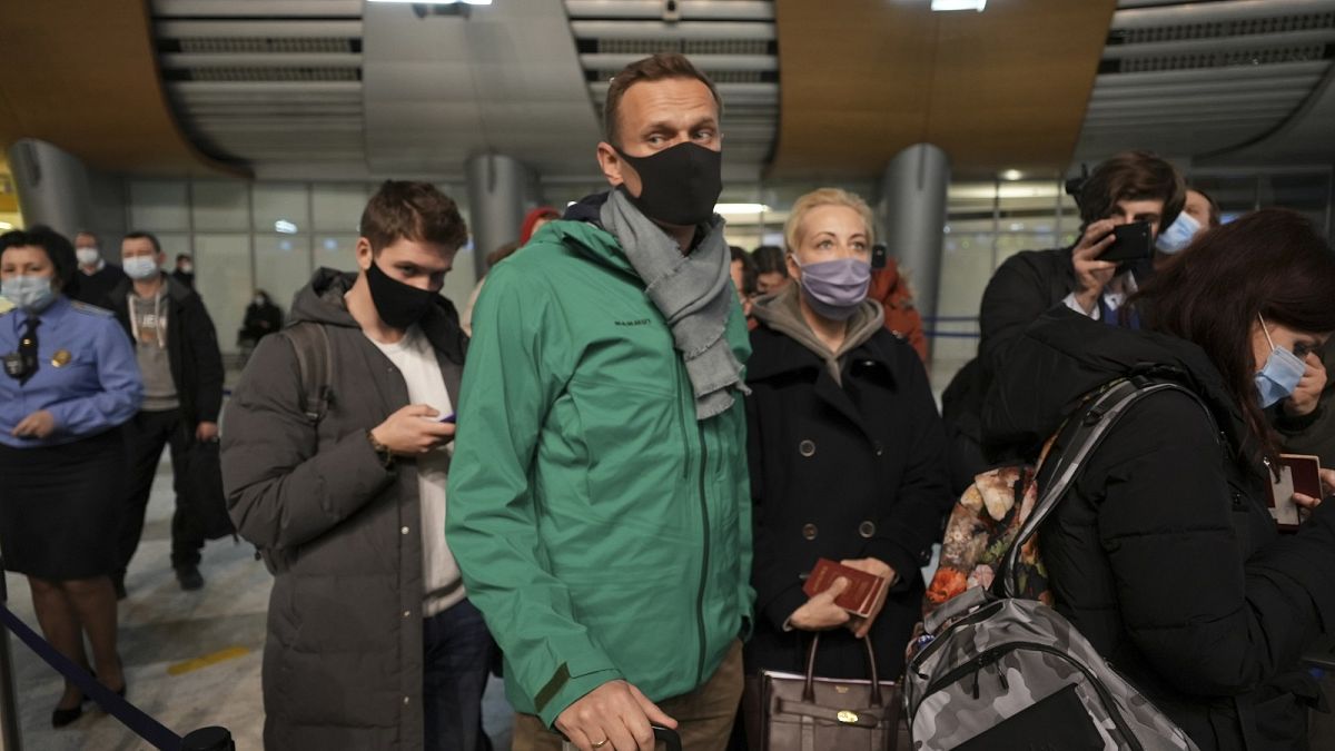 Alexei Navalny and his wife Yuliastand in line at the passport control after arriving at Sheremetyevo airport, outside Moscow, Russia, Sunday, Jan. 17, 2021.