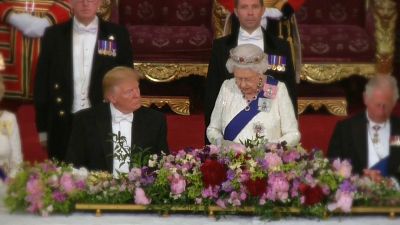 US president sitting next to the Queen of England