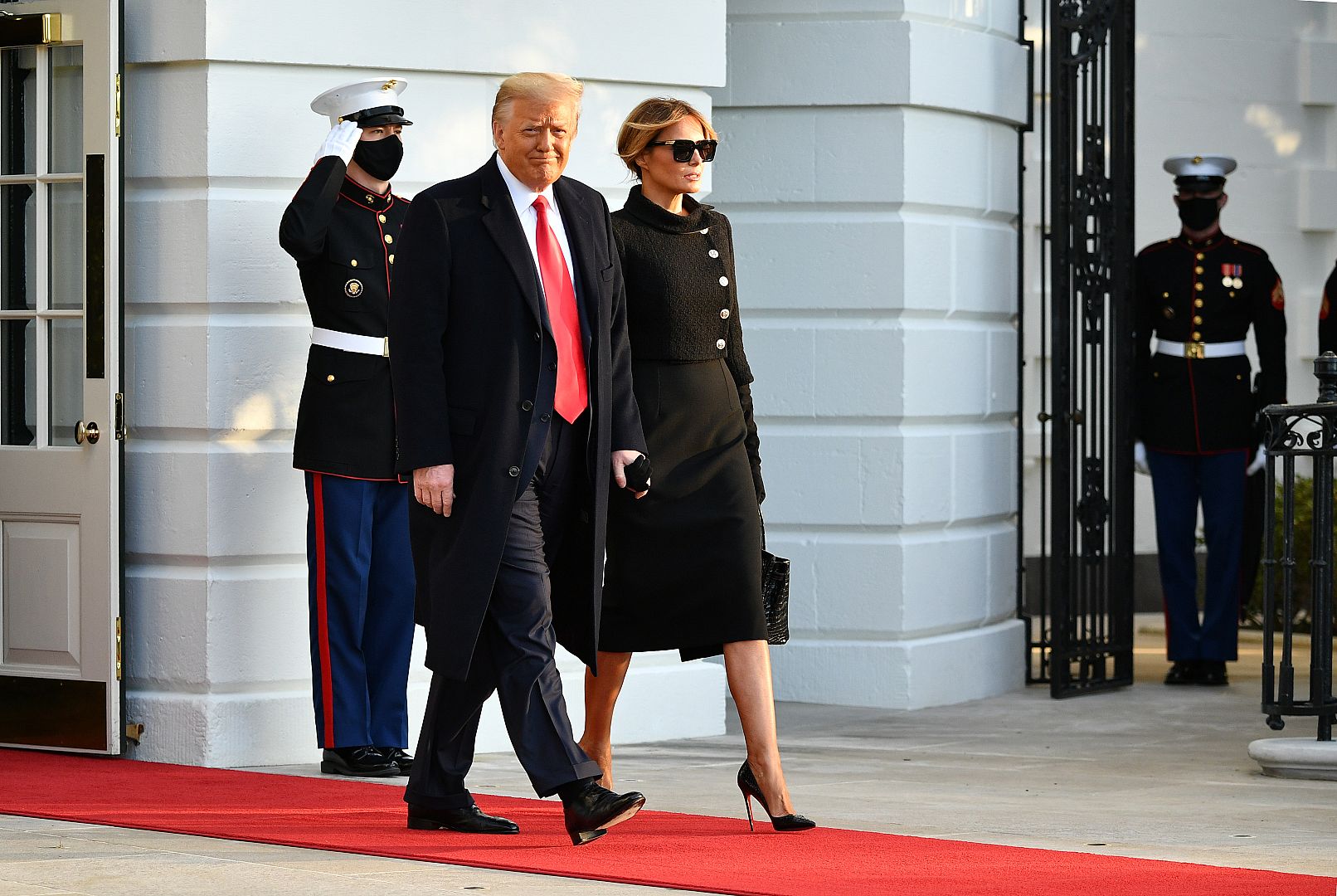 US President Donald Trump and First Lady Melania make their way to board Marine One before departing from the South Lawn of the White House in Washington, DC on January 20, 20