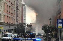 Smoke rises from a building and rubble scattered in Toledo Street following a explosion in downtown Madrid, Spain, Wednesday, Jan. 20, 2021.