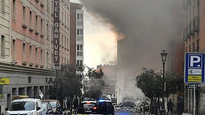 Smoke rises from a building and rubble scattered in Toledo Street following a explosion in downtown Madrid, Spain, Wednesday, Jan. 20, 2021.