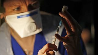 Doctor Claire Chatt prepares the Pfizer-BioNTech vaccine inside Salisbury Cathedral in Salisbury, England