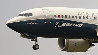 FILE- A Boeing 737 Max jet prepares to land following a test flight in Seattle.