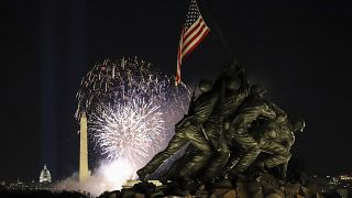 Fireworks to mark the Biden inauguration explode over the Washington Monument with the Marine Corps War Memorial in the foreground, Wednesday, Jan. 20, 2021, in Arlington, Va.