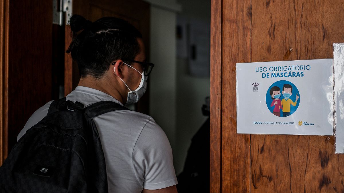 Um estudante entra de máscara numa sala de aula em Portugal