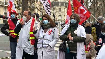 Health care workers protest outside the French health ministry in Paris, Thursday, January 21, 2021.