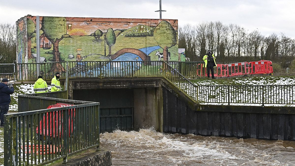 Environment Agency workers flood a storm basin near the River Mersey in Didsbury, north west England, to view flood defences put in place for Storm Christoph, Jan. 21, 2021.