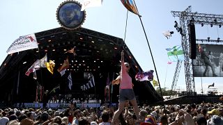 In this Sunday, June 30, 2019 file photo, revellers react to Kylie Minogue as she performs at the Glastonbury Festival, Somerset, England.