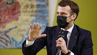 French President Emmanuel Macron gestures as he meets students during his visits at Paris-Sarclay university in Orsay, west of Paris, Thursday, Jan. 21, 2021.