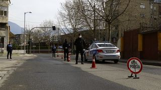 Police stand at a checkpoint in Tirana last March.