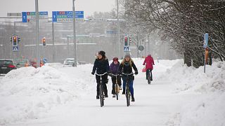 Cyclists in the snow in Oulu, Finland